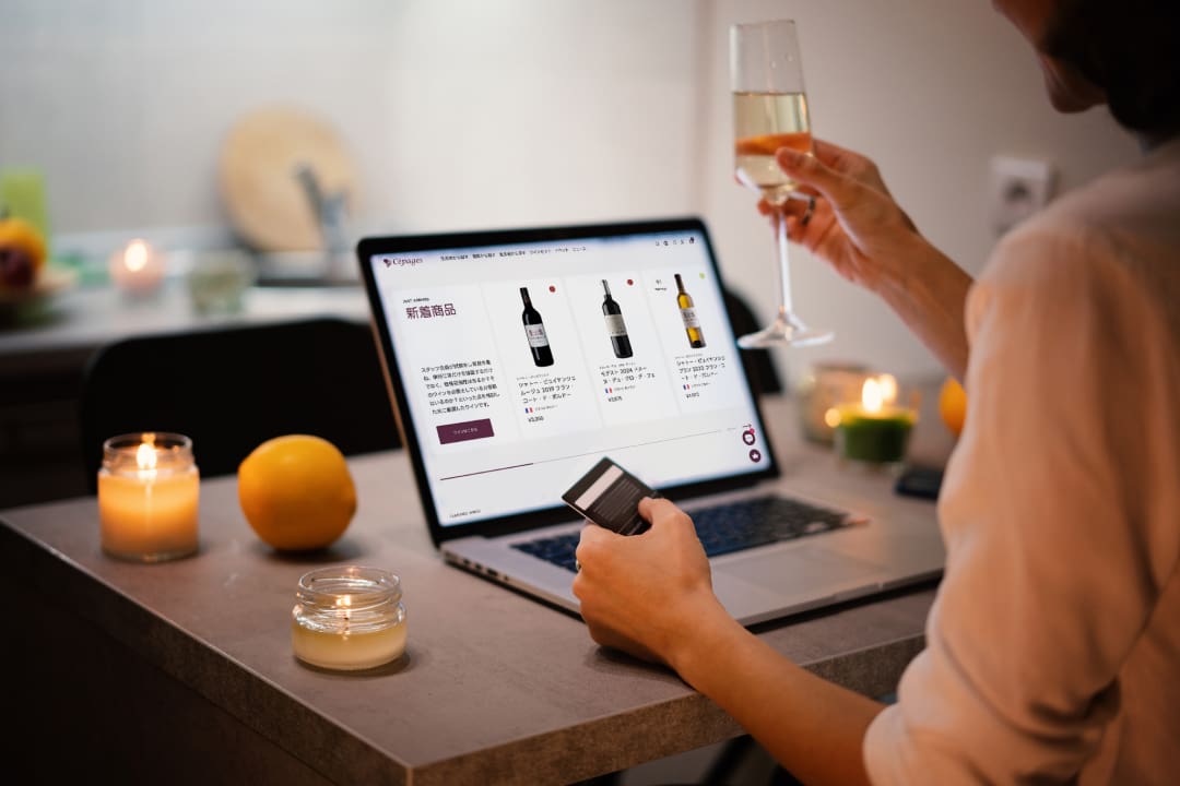A Japanese wine enthusiast choosing a bottle to order on Wine Kiosk website